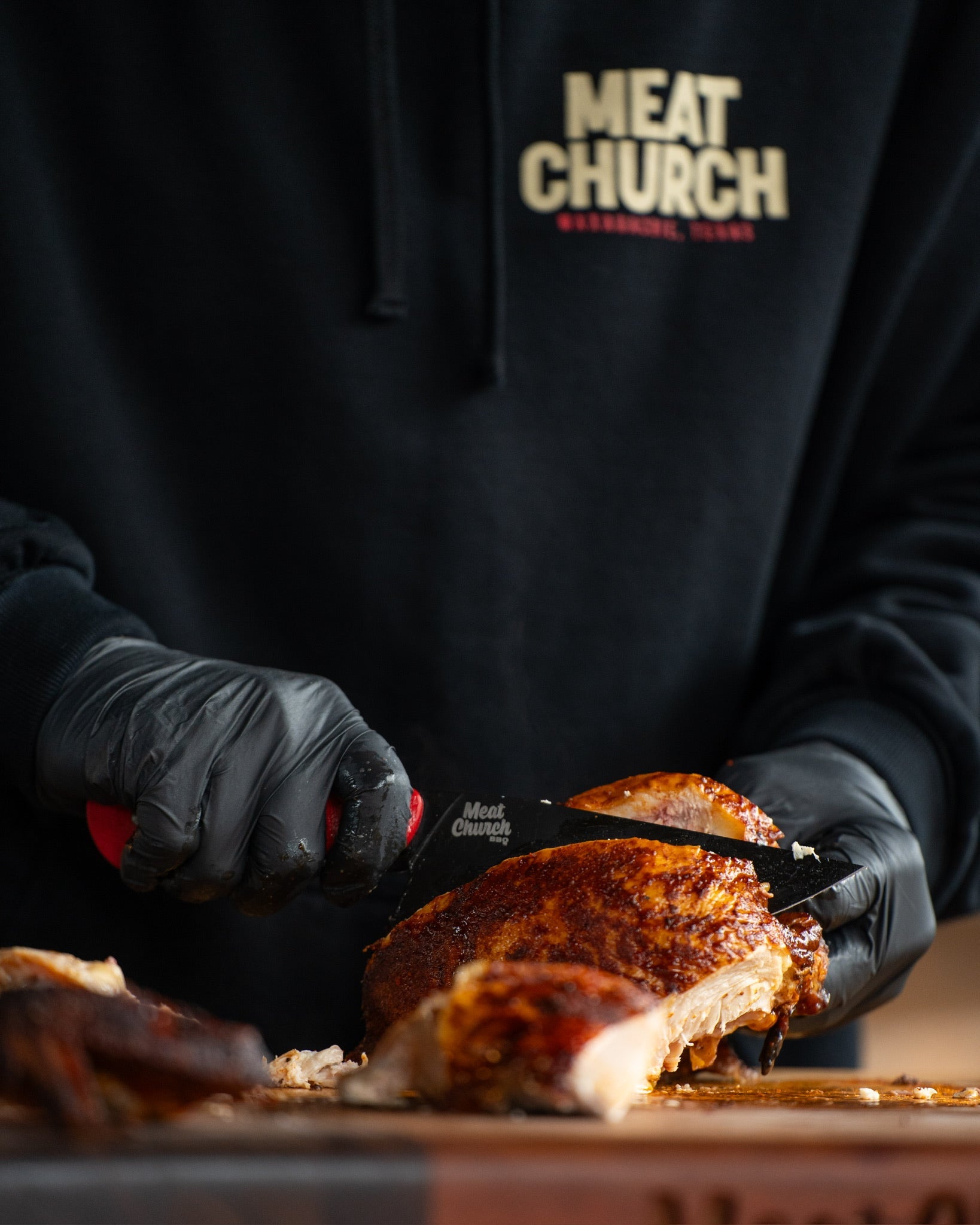 Pitmaster slicing freshly cooked barbecue